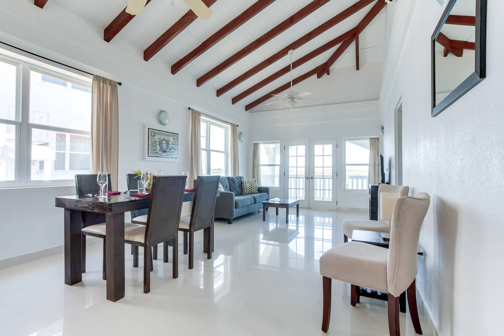 Dining room with a wooden dining table and four chars inside the 2 Bedroom Lagoon Bayview at Umaya Resort & Adventure
